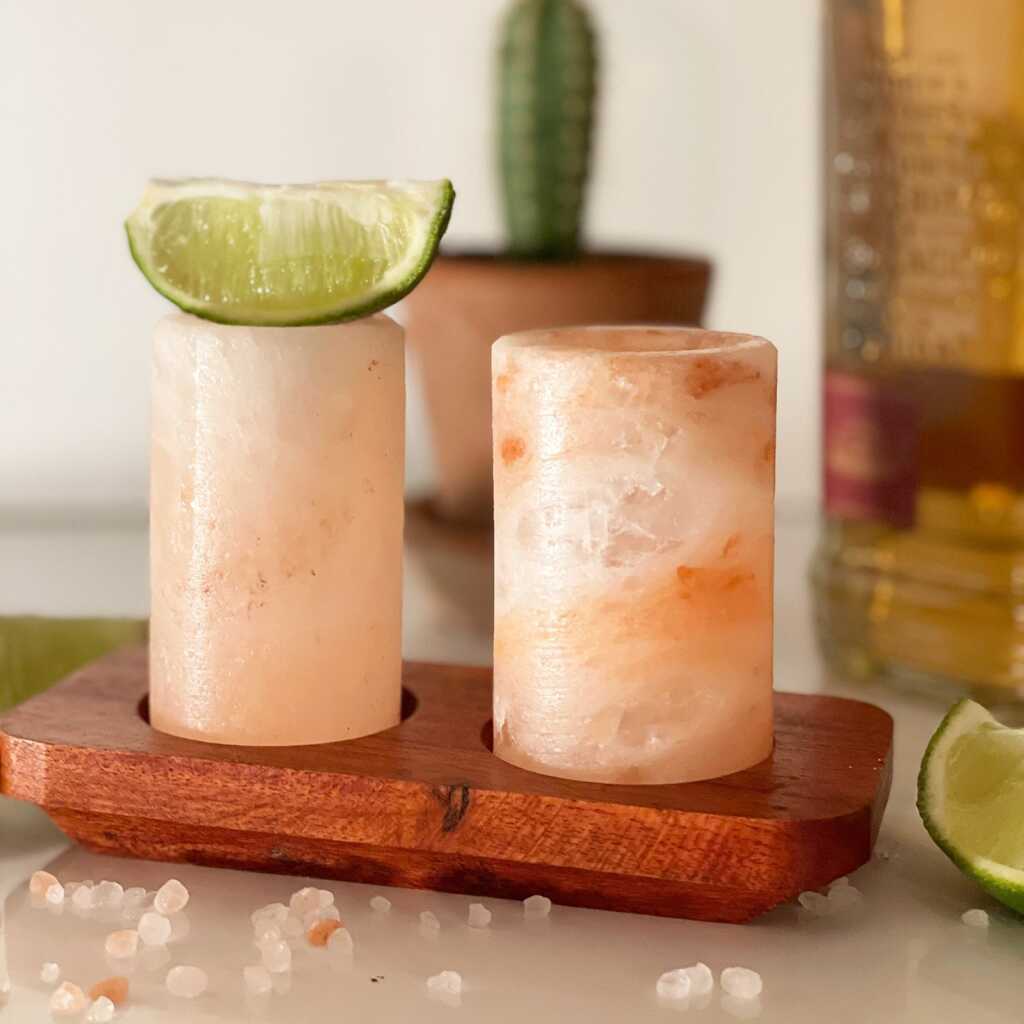 two rock salt shot glasses with lime