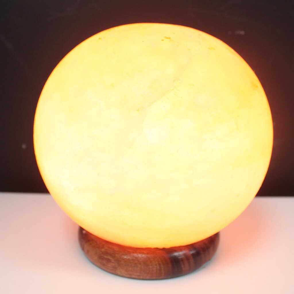 an Himalayan salt lamp ball on a wooden base