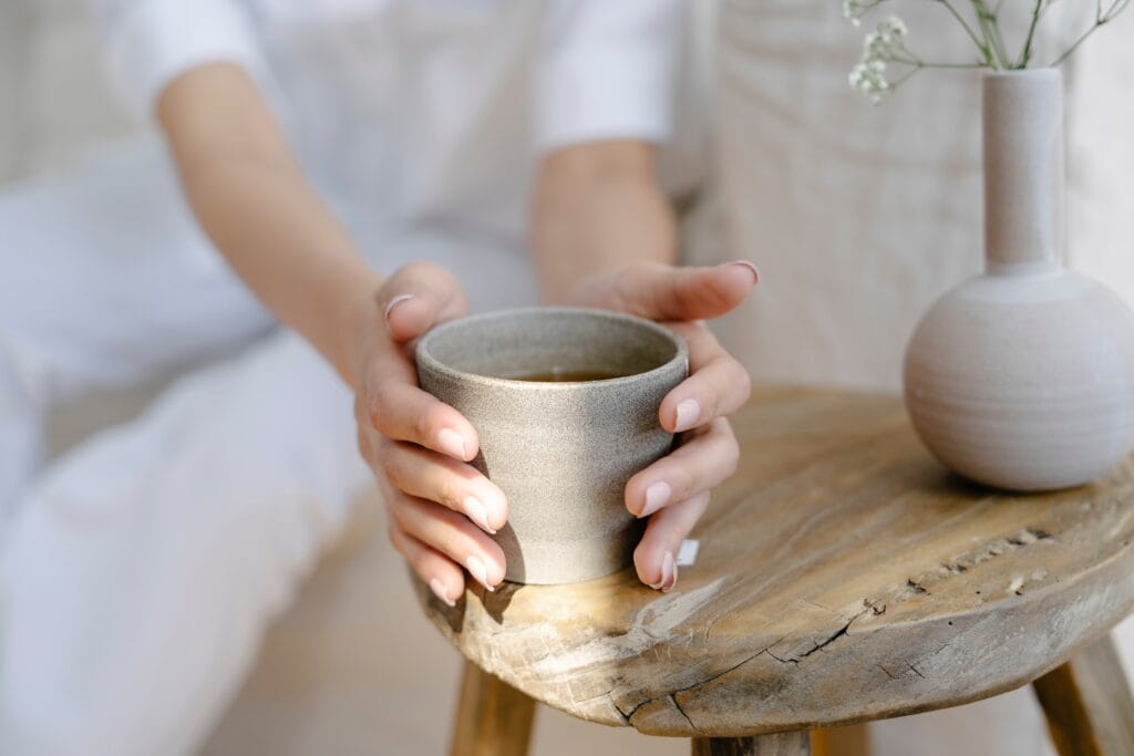 the pleasure of tea is two hands around a teacup