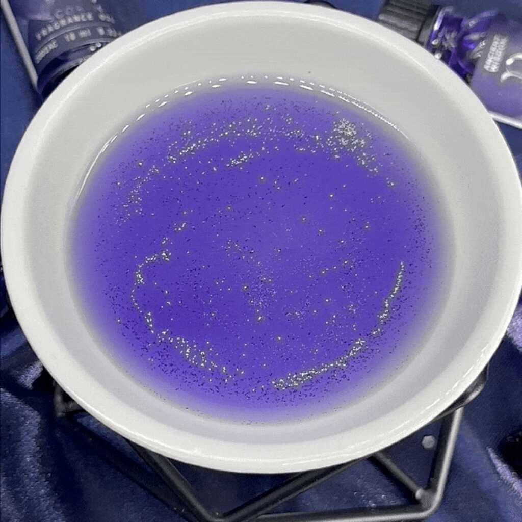 Zodiac Fragrance Oil in a white dish showing glitter.