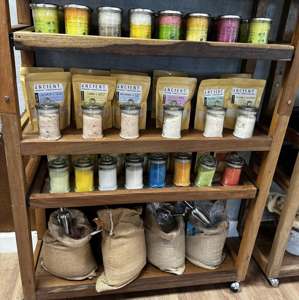 bath potions in packets and sacks on a wooden shelf