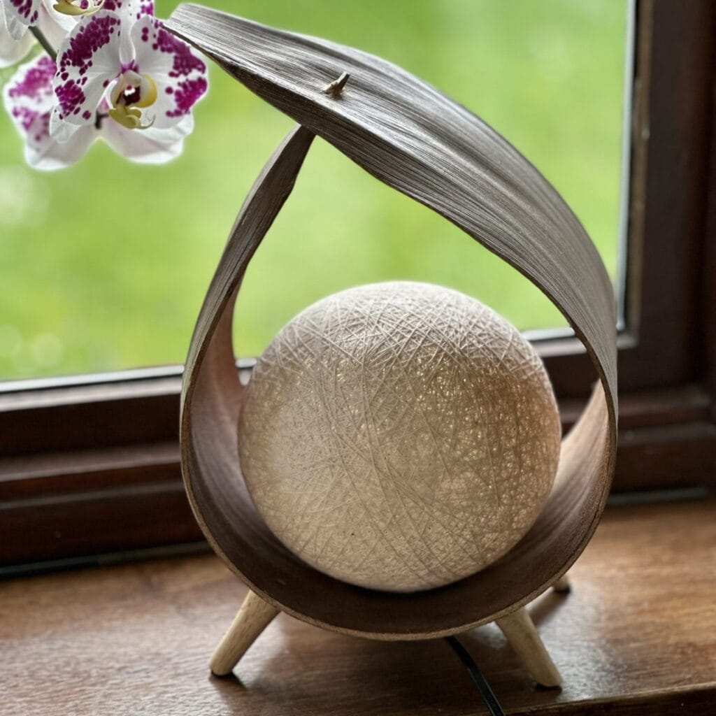an unlit coconut leaf lamp on a windowsill