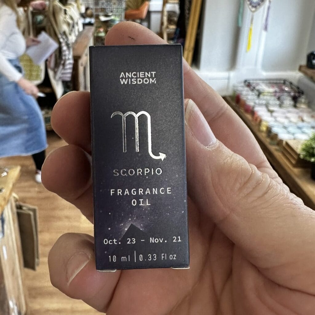 scorpio fragrance oil being held in a hand