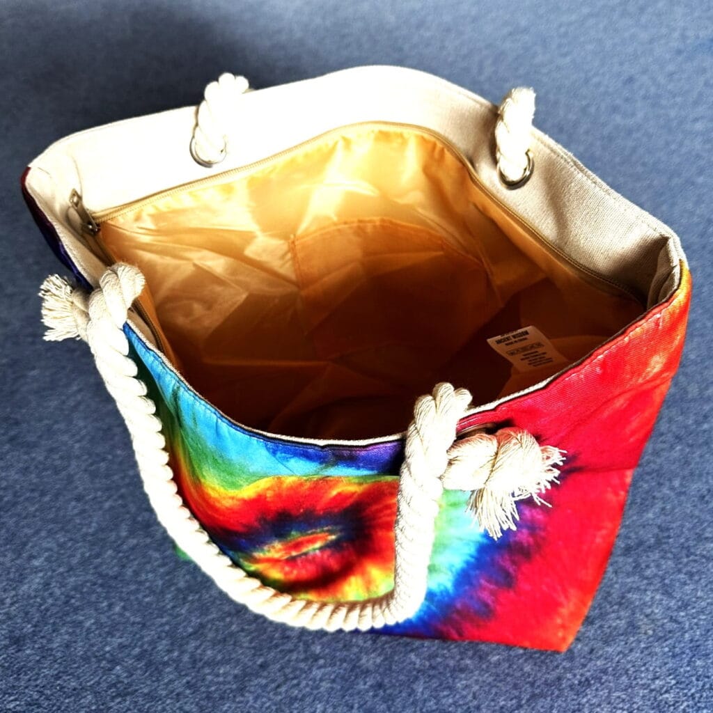 tina holding a psychedelic splash bag in bright spiral colours - pure energy