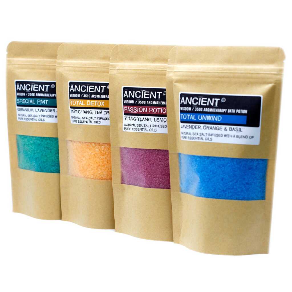 a selection of four different coloured Aromatherapy Bath Potion packets in a line