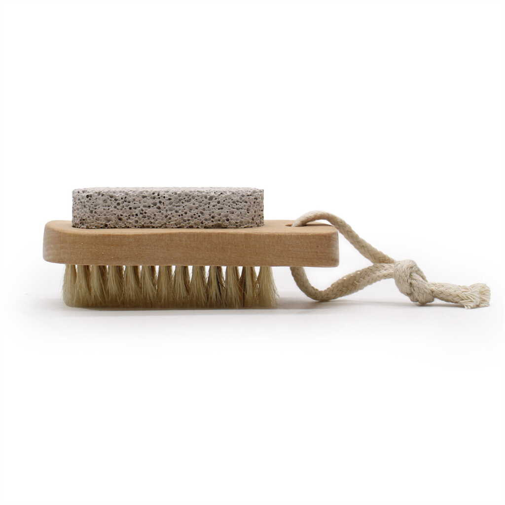 a face and body brush and stone with a brush on top and a stone on the bottom