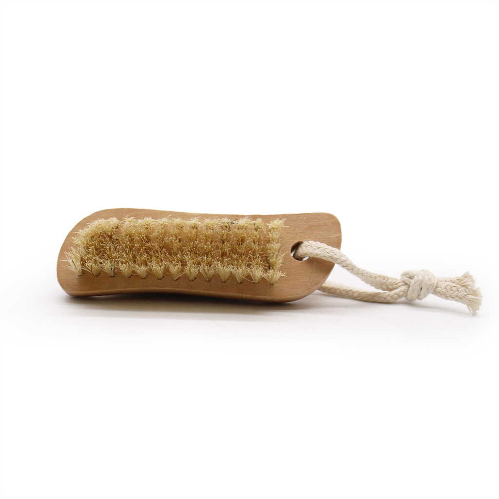 a face and body brush with a brush on top and a stone on the bottom - showing the brush