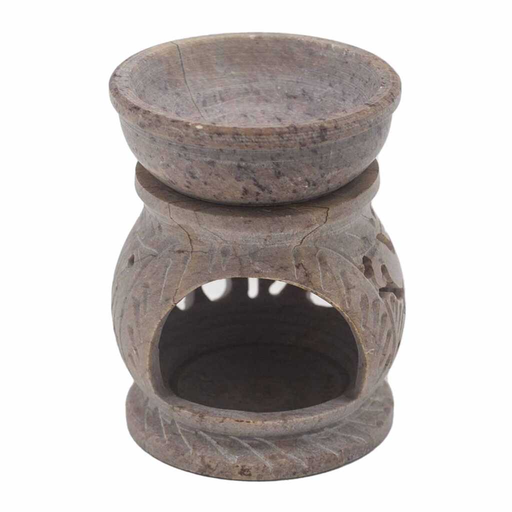 a soapstone oil burner with an elephant design.