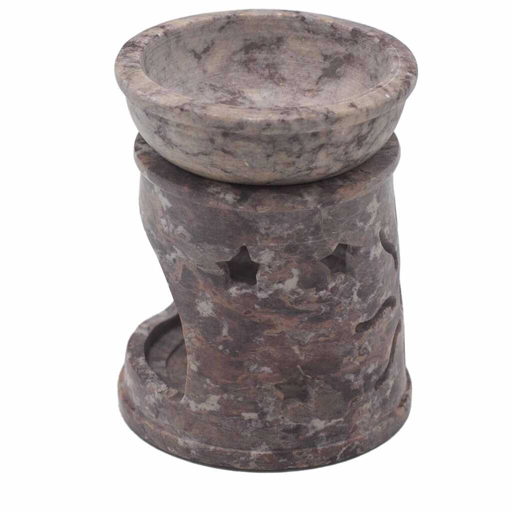 a soapstone oil burner with a sun and stars design.