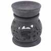 a soapstone oil burner with an Om symbol design.