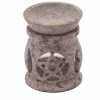 a soapstone oil burner with a three moon pentagon design.