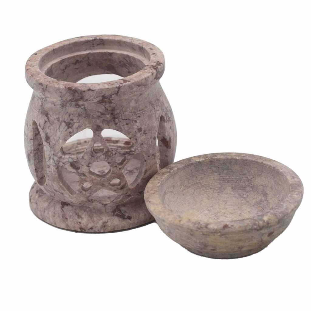 a soapstone oil burner with a three moon pentagon design, showing the body and the top bowl separately.