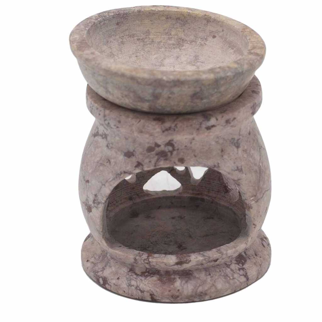 a soapstone oil burner with a three moon pentagon design.