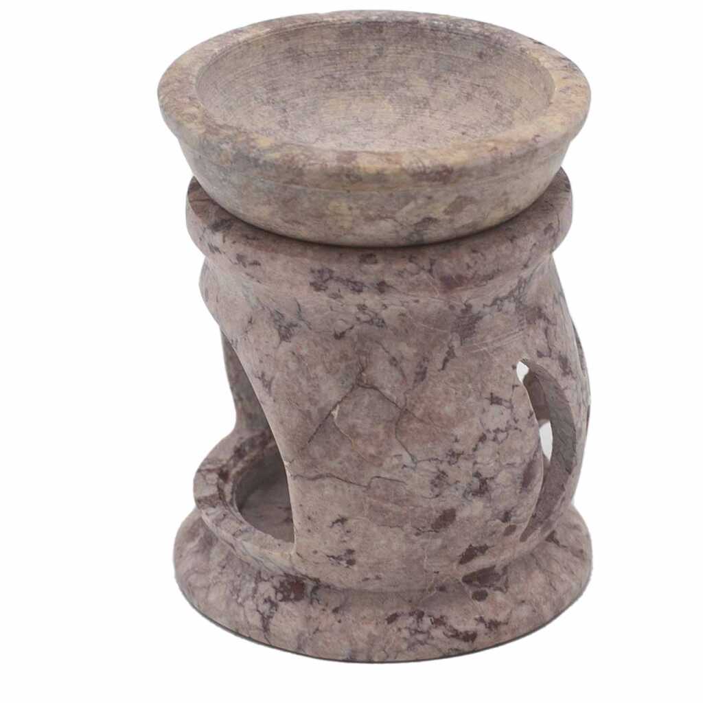 a soapstone oil burner with a three moon pentagon design.