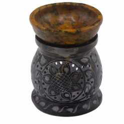 a yellow and black soapstone oil burner with a mandala flower design.
