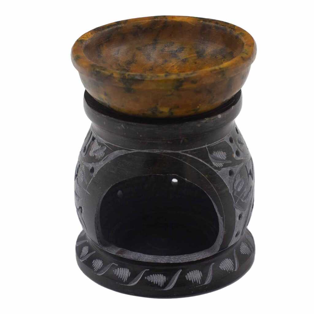 a yellow and black soapstone oil burner with a mandala flower design.