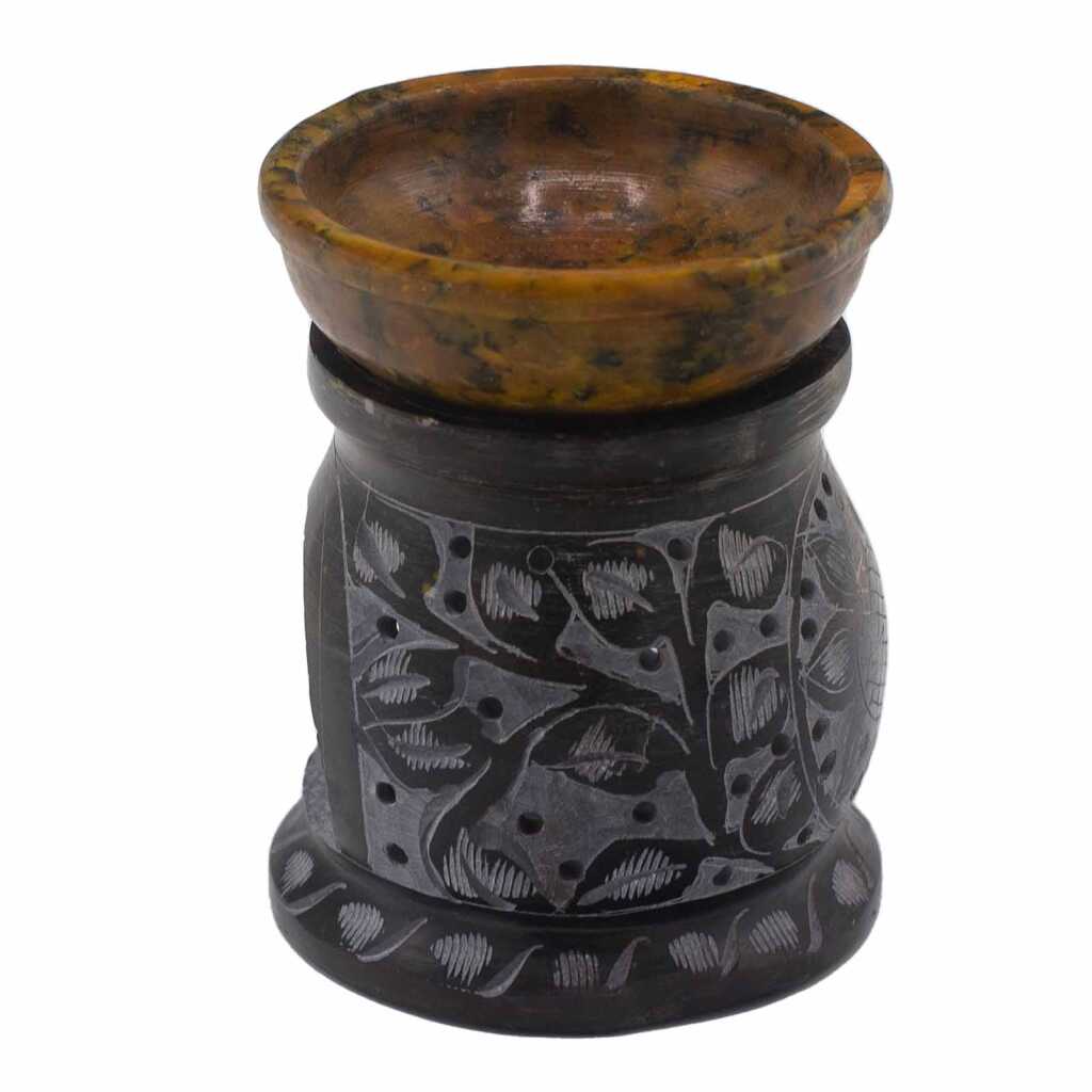 a yellow and black soapstone oil burner with a mandala flower design.