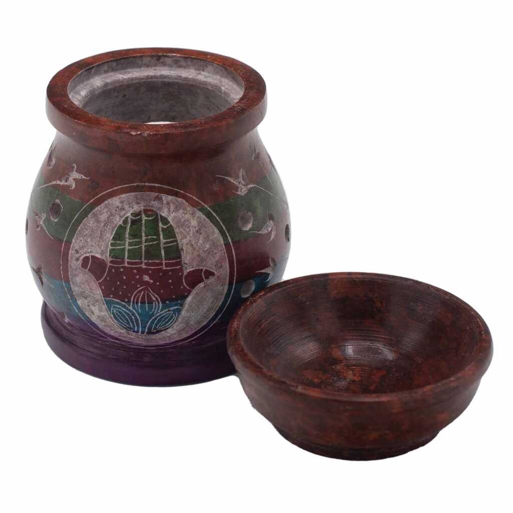 a five coloured soapstone oil burner with a hamsa design, showing the base and top bowl separately.