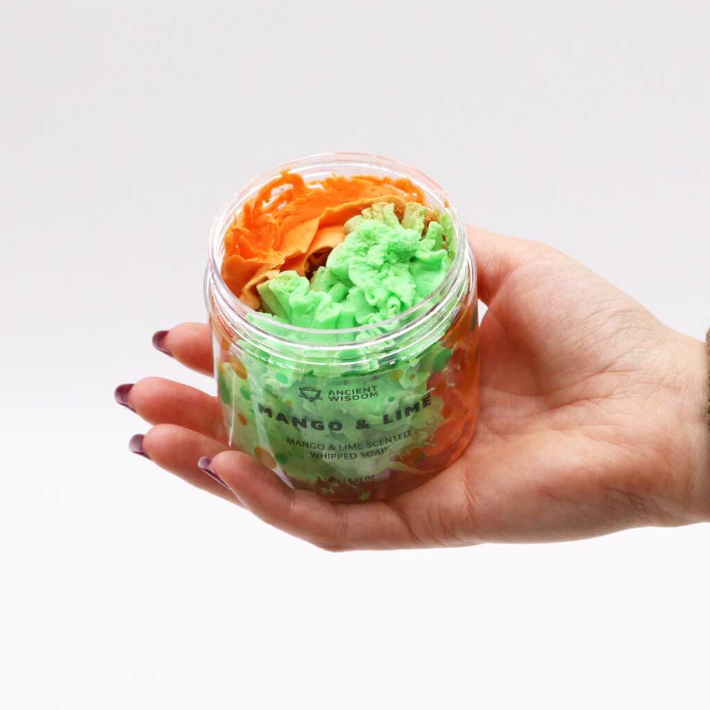 mango and lime scented whipped soap - green and orange - open jar in open hand