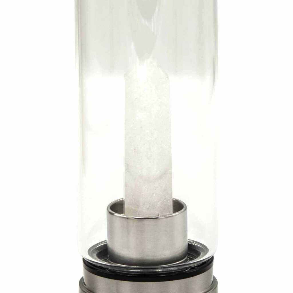 A clear quartz obelisk, crystal infused water bottle
