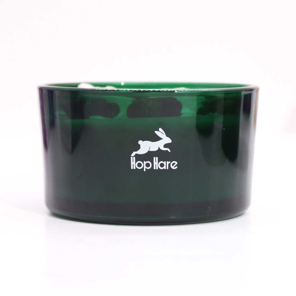 Hop Hare candle dish, made of green glass with hop hare logo