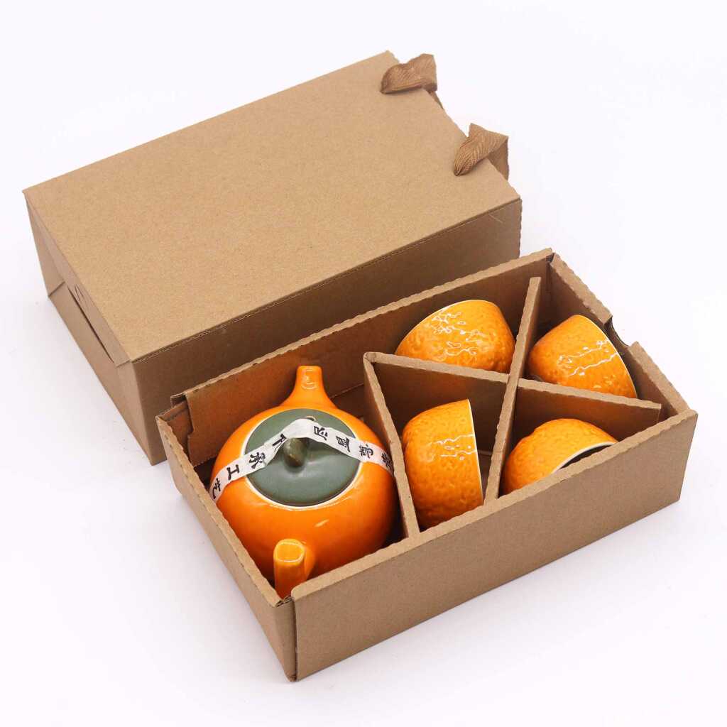a herbal orange themed teapot set with four matching cups in a presentation box