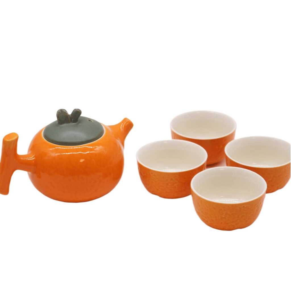 a herbal orange themed teapot set with four matching cups