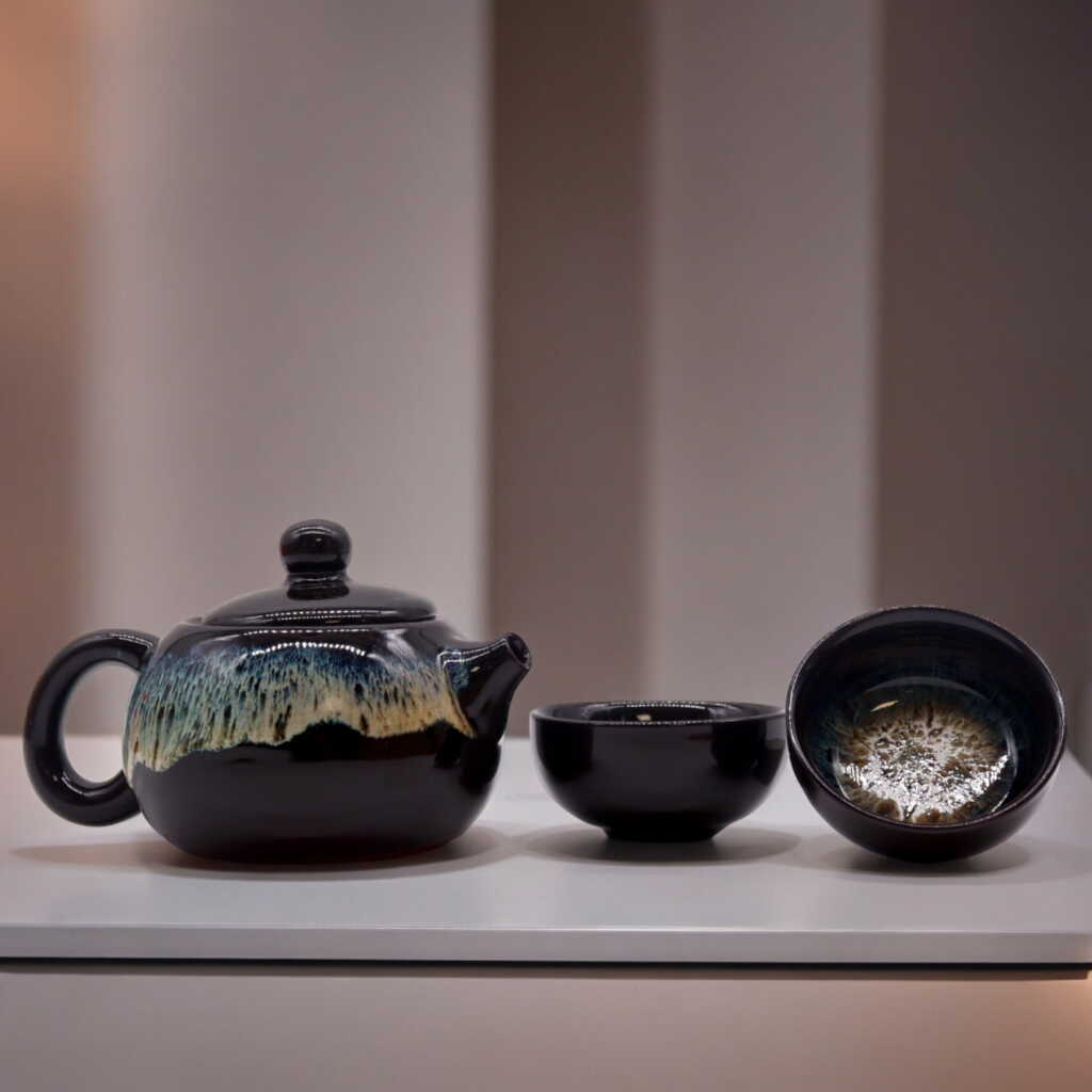 a herbal black glaze themed teapot set with two matching cups