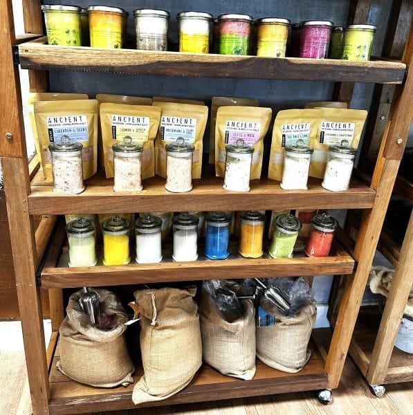 bath potion on the bottom shelf with other bathtime products above