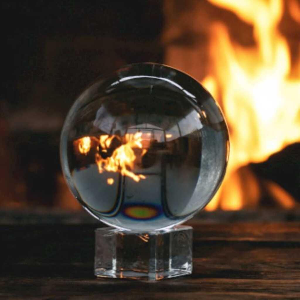 a crystal ball in front of an open fire.