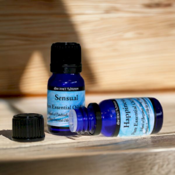 Two blue bottles of essential oil blends