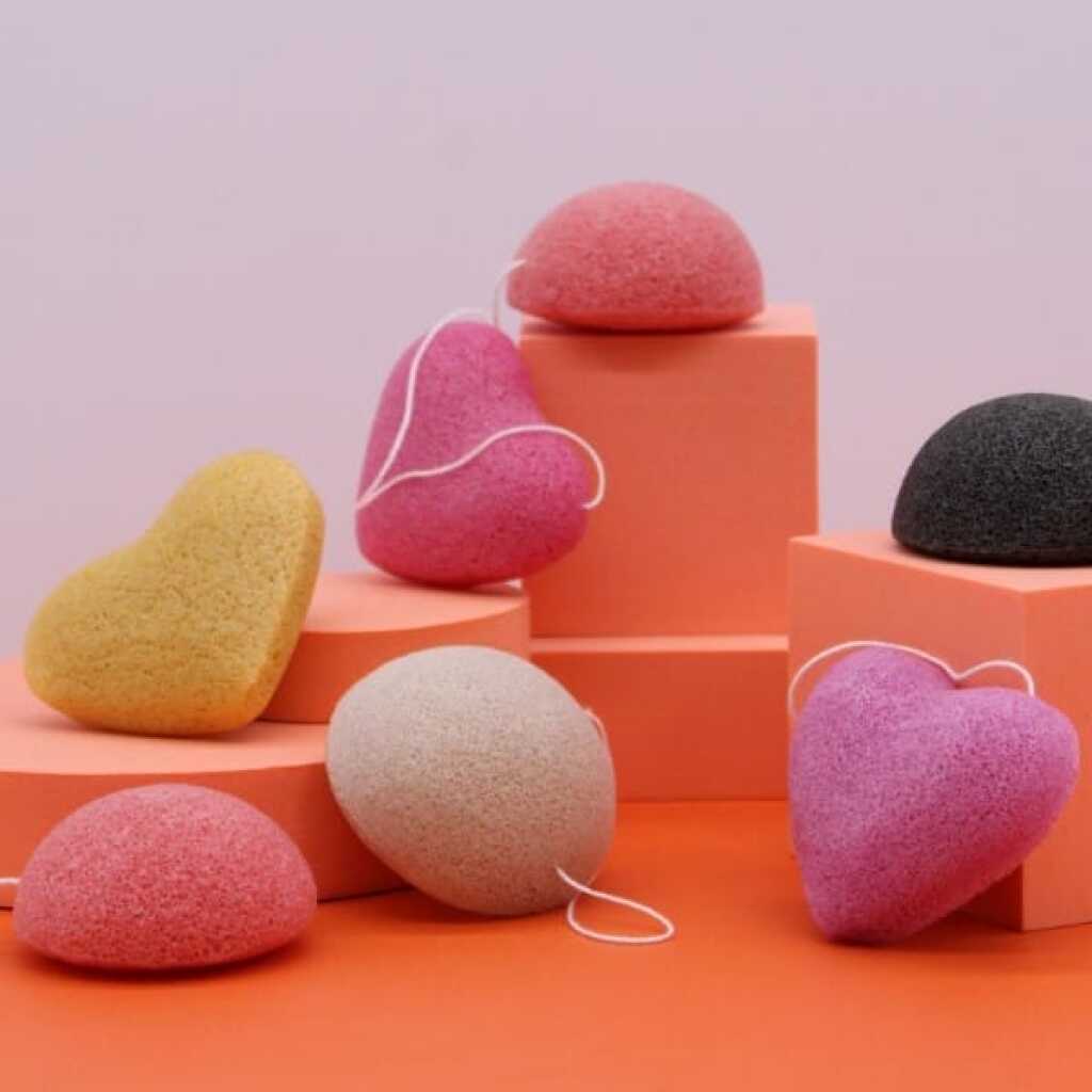 6 japan style konjac sponges of various colours on an orange background