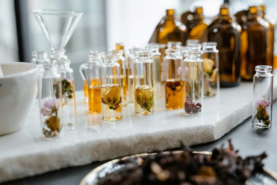 a selection of flower-based ingredients in small jars
