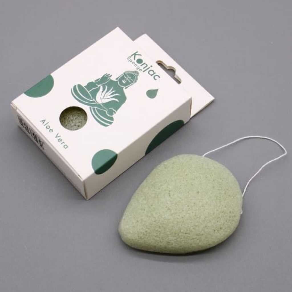 a light green coloured teardrop konjac sponge infused with aloe vera, pictured with its packaging