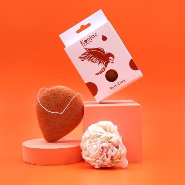 a natural konjac sponge and box on an orange display unit