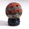 A gemstone planet (Mars) on a goldstone stand