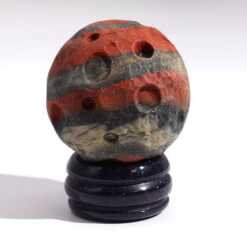 A gemstone planet (Mars) on a goldstone stand