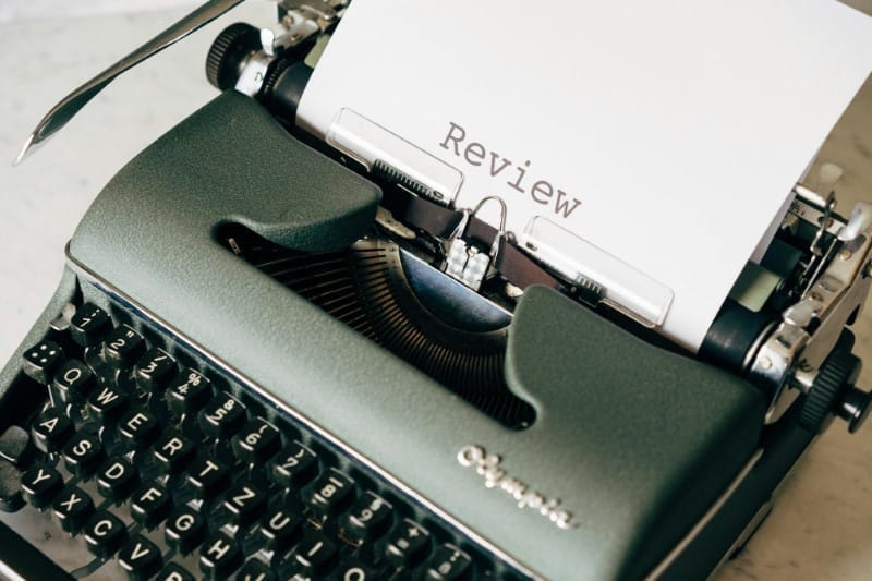 a product review document being written on a typewriter.