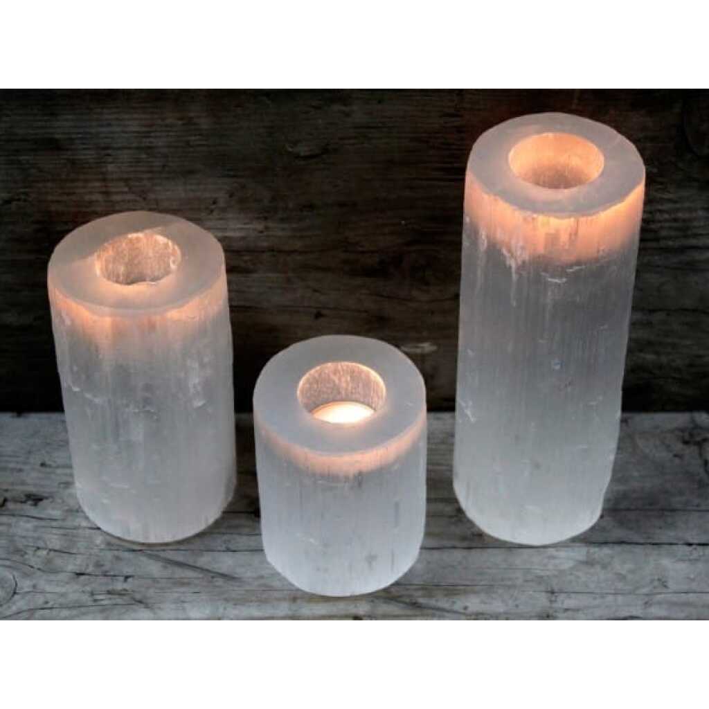 a set of three selenite cylinder candle holders