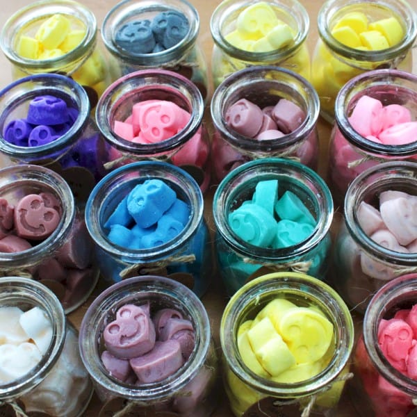 a display of coloured soy wax melt jars