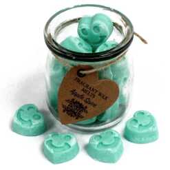 a jar of soy wax melts with four in front - apple spice