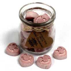 a jar of soy wax melts with four in front - dark sandalwood