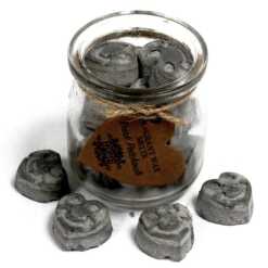 a jar of soy wax melts with four in front - dark patchouli