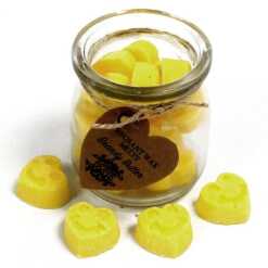 a jar of soy wax melts with four in front - brandy butter