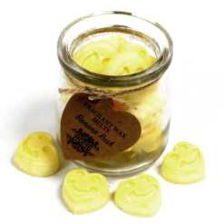 a jar of soy wax melts with four in front - banana rush