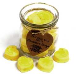 a jar of soy wax melts with four in front - cinnamon and orange
