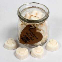 a jar of soy wax melts with four in front - white musk