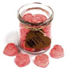a jar of soy wax melts with four in front - tuberose