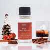 a 10ml clear bottle of Hot Chocolate fragrance oil in a christmas setting