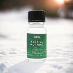 a 10ml clear bottle of Festive morning fragrance oil in a christmas setting